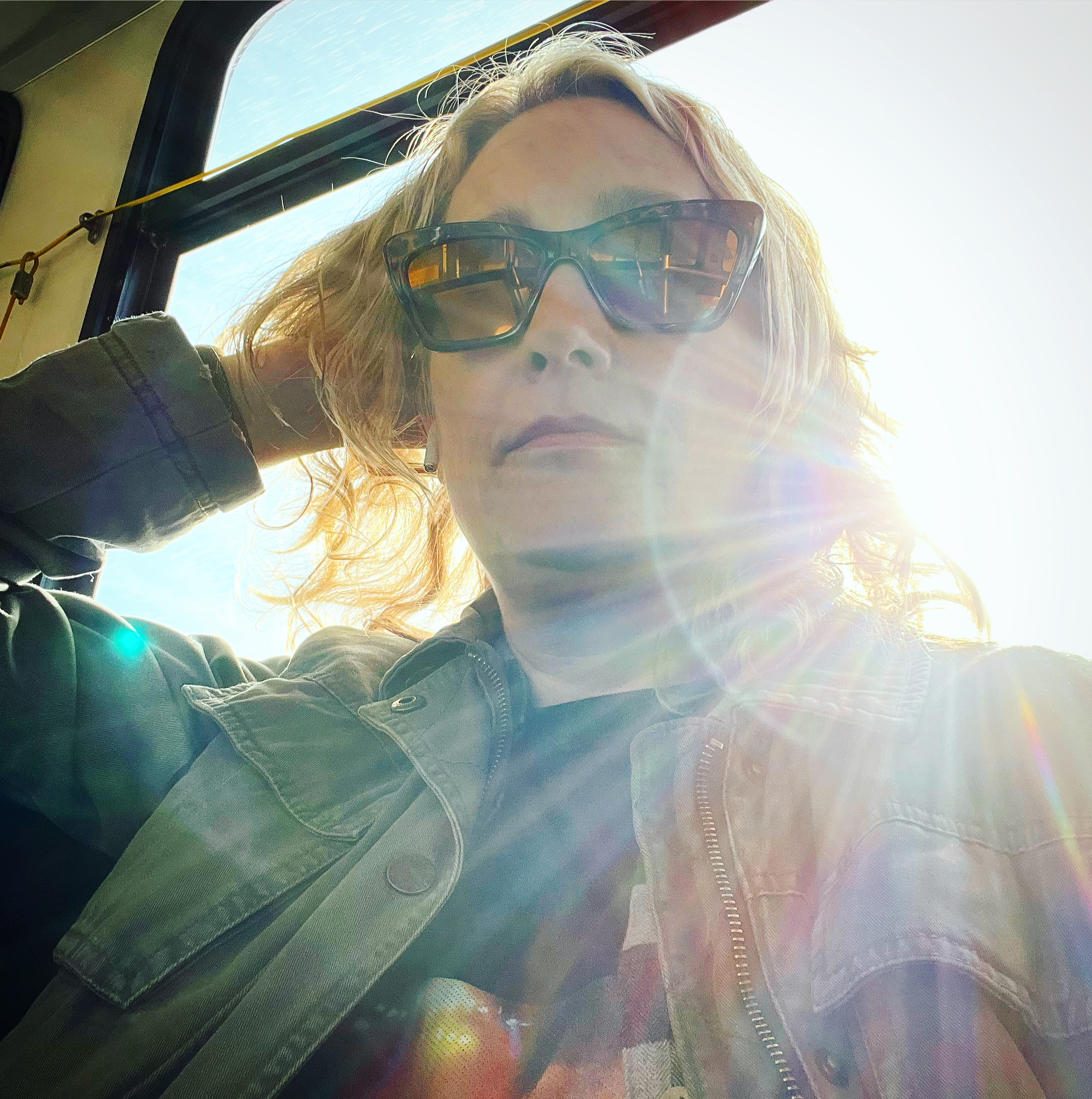A photo of Jill Roberts wearing sunglasses with the sun shining over her left shoulder.